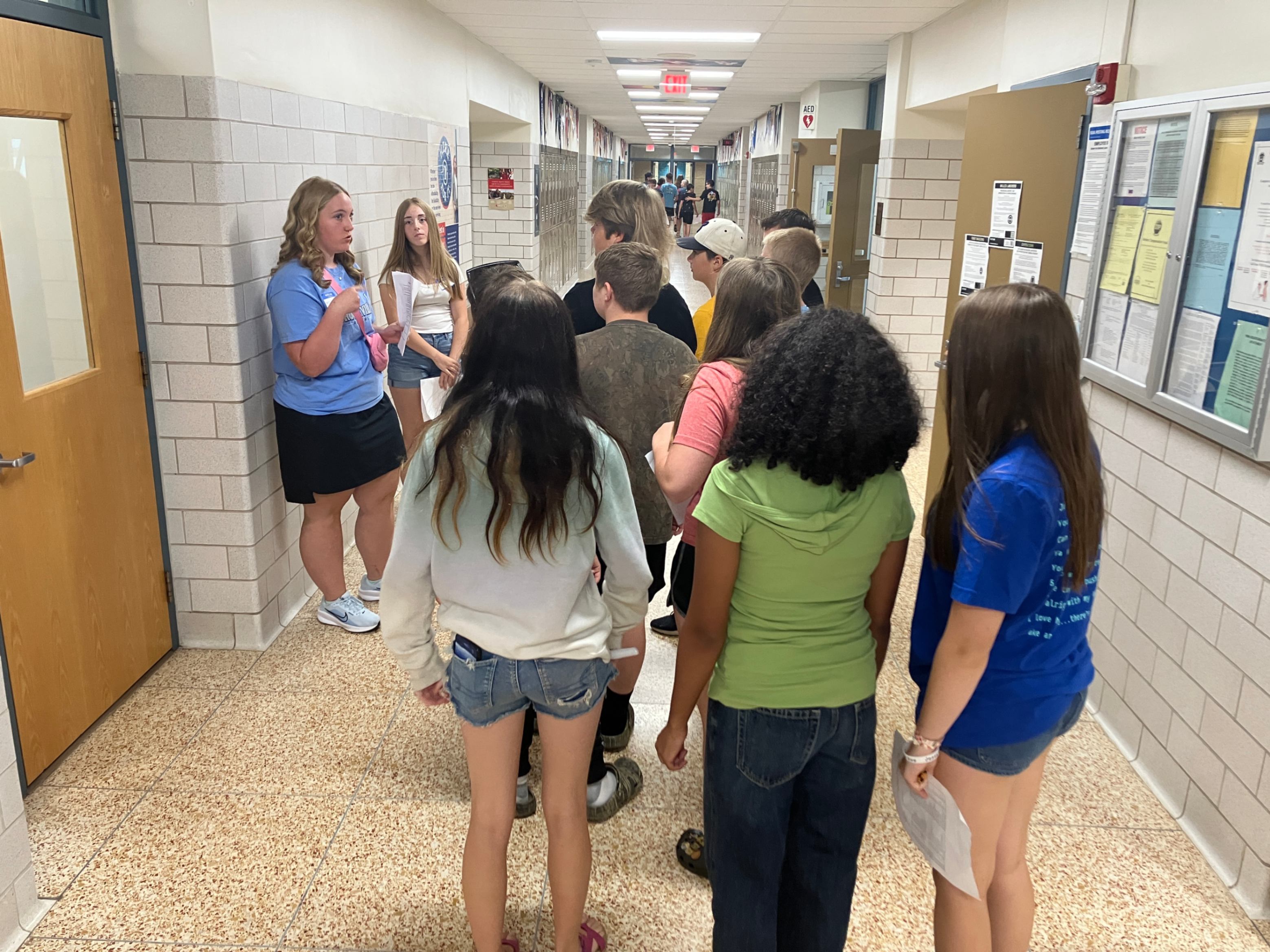 A group of students gather together in a high school hallway during the recent Bridge Camp.